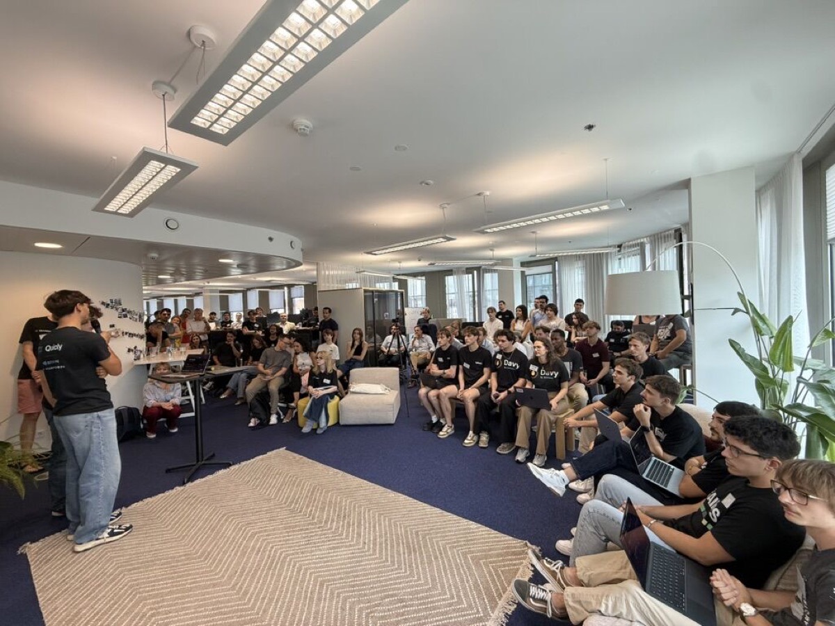 The Quicly team presenting to a seated audience at the Demo Day.